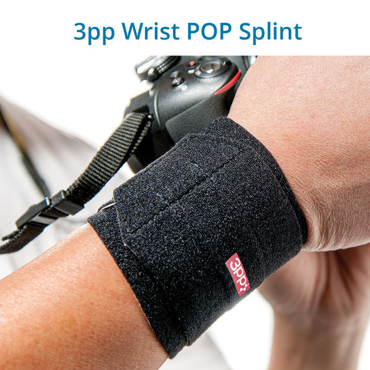 A person's wrist wearing a black 3pp Wrist POP Splint, designed for supporting the wrist and controlling pressure to alleviate pain from TFCC injuries and ulnar-sided wrist pain.