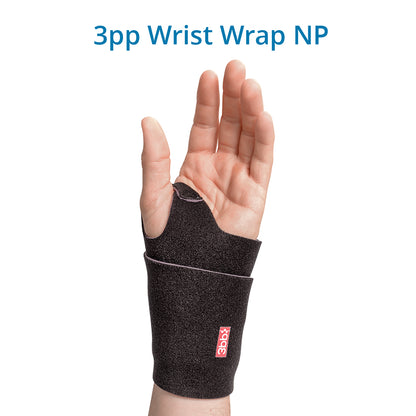 A person’s wrist wearing a black 3pp Wrist Wrap NP with a removable plastic stay for support. Provides relief from wrist pain caused by arthritis, Ehlers-Danlos syndrome, tendinitis, strains, or sprains