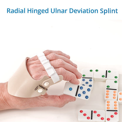 A person’s hand wearing a beige Radial Hinged Ulnar Deviation Splint, holding dice during a game of dominoes. The splint helps straighten moderately to severely deviated fingers, making daily activities easier